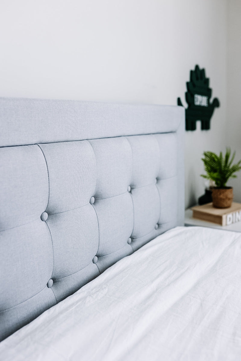 Light gray upholstered headboard paired with a neatly made Zinus mattress, highlighting tufted fabric details, clean stitching, and a modern, minimalist bedroom style that emphasizes comfort, support, and soft, neutral design.