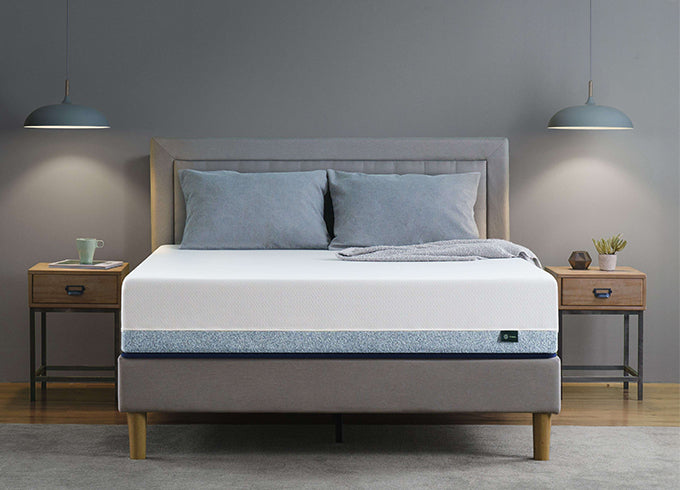 Zinus Cooling mattress on upholstered platform bed with gray headboard, styled in bedroom with twin wooden nightstands, pendant lamps, and gray bedding.