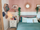 Cozy bedroom with blush pink accent wall and white wainscoting, wooden spindle headboard, and teal bedding accented by cream pillows; sunburst mirror, hanging plants, and wall-mounted shelves add warmth, complemented by a white nightstand with books, lamp, and floral decor.