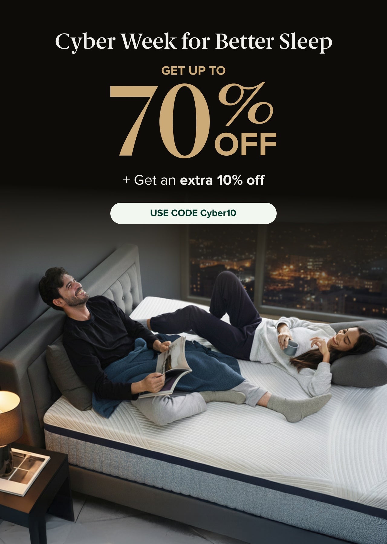 Cyber Week for Better Sleep. Get up to 70% off. + Get an extra 10% off. Use code Cyber10.” Below the text, two adults relax on a tufted-headboard bed; one reads a magazine while the other holds a mug, lying on a white contoured mattress in a high-rise bedroom at night.