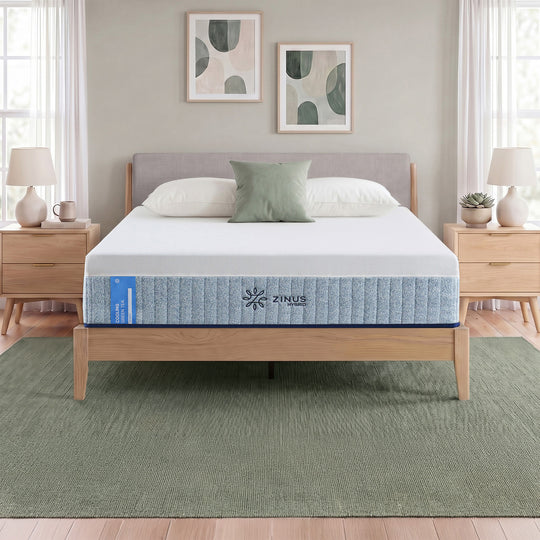Zinus Cooling Green Tea Hybrid Mattress, Queen, staged on wood platform bed frame in bedroom with white pillows, sage cushion, and side label text reading cooling green tea hybrid.