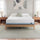 Zinus Original Green Tea Hybrid Mattress, Queen, on light wood platform bed frame in bright bedroom with white and sage pillows, matching nightstands, lamps, books, and a succulent plant.