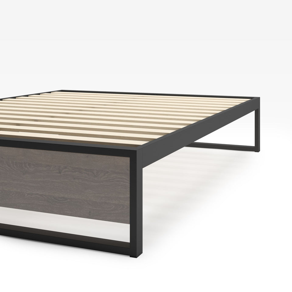 Close-up of Zinus Suzanne Metal and Bamboo Platform Bed Frame corner detail. Shows black steel frame construction, bamboo wood accent, and slatted mattress base. Sturdy design built for long-lasting durability and modern bedroom style