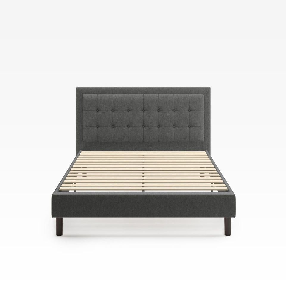 Zinus Dachelle Upholstered Platform Bed Frame in dark gray with square tufted headboard and wooden slats for mattress support. Low-profile modern frame with sturdy legs, designed for lasting durability and contemporary bedroom appeal.