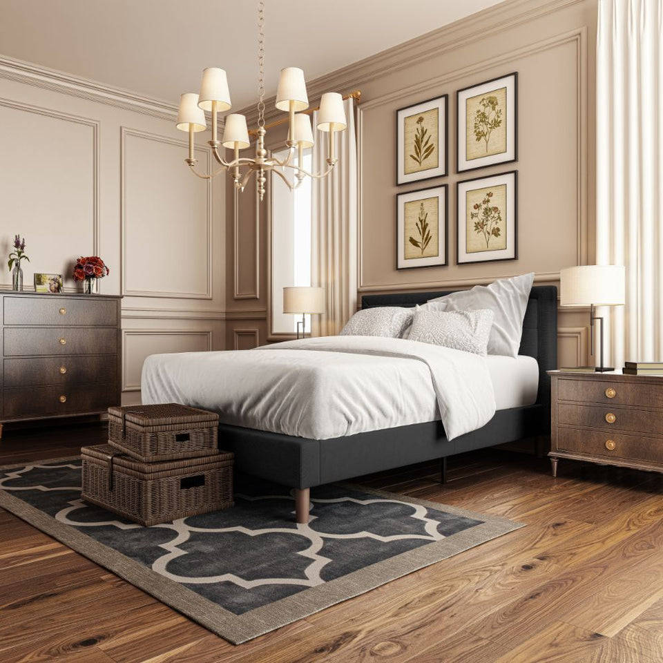 Zinus Dachelle Upholstered Platform Bed Frame in dark gray styled in an elegant bedroom with wood flooring, chandelier, and nightstands. Square tufted headboard and strong slat support make this platform bed both modern and durable