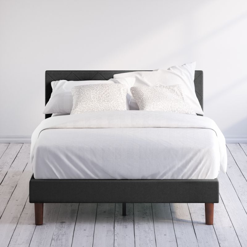 Zinus Shalini Upholstered Platform Bed Frame styled with white bedding in a minimal bedroom. The diamond-stitched headboard in dark gray fabric adds sophistication, while durable slats provide strong mattress support without the need for a box spring