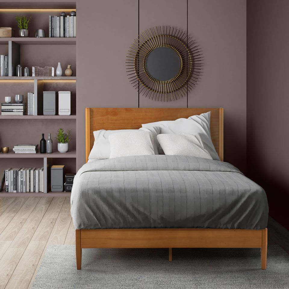 Zinus Allen Wood Platform Bed Frame styled in a modern bedroom with soft gray bedding and accent pillows. Natural wood frame and headboard create a warm, clean-lined centerpiece. Platform design offers durable mattress support and underbed clearance for versatile storage.