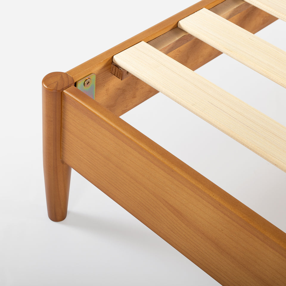Close-up of Zinus Allen Wood Platform Bed Frame corner detail in natural finish. Solid wood frame features clean lines, rounded legs, and secured wooden slats for strength and stability. Crafted for lasting durability and modern simplicity, it provides strong mattress support
