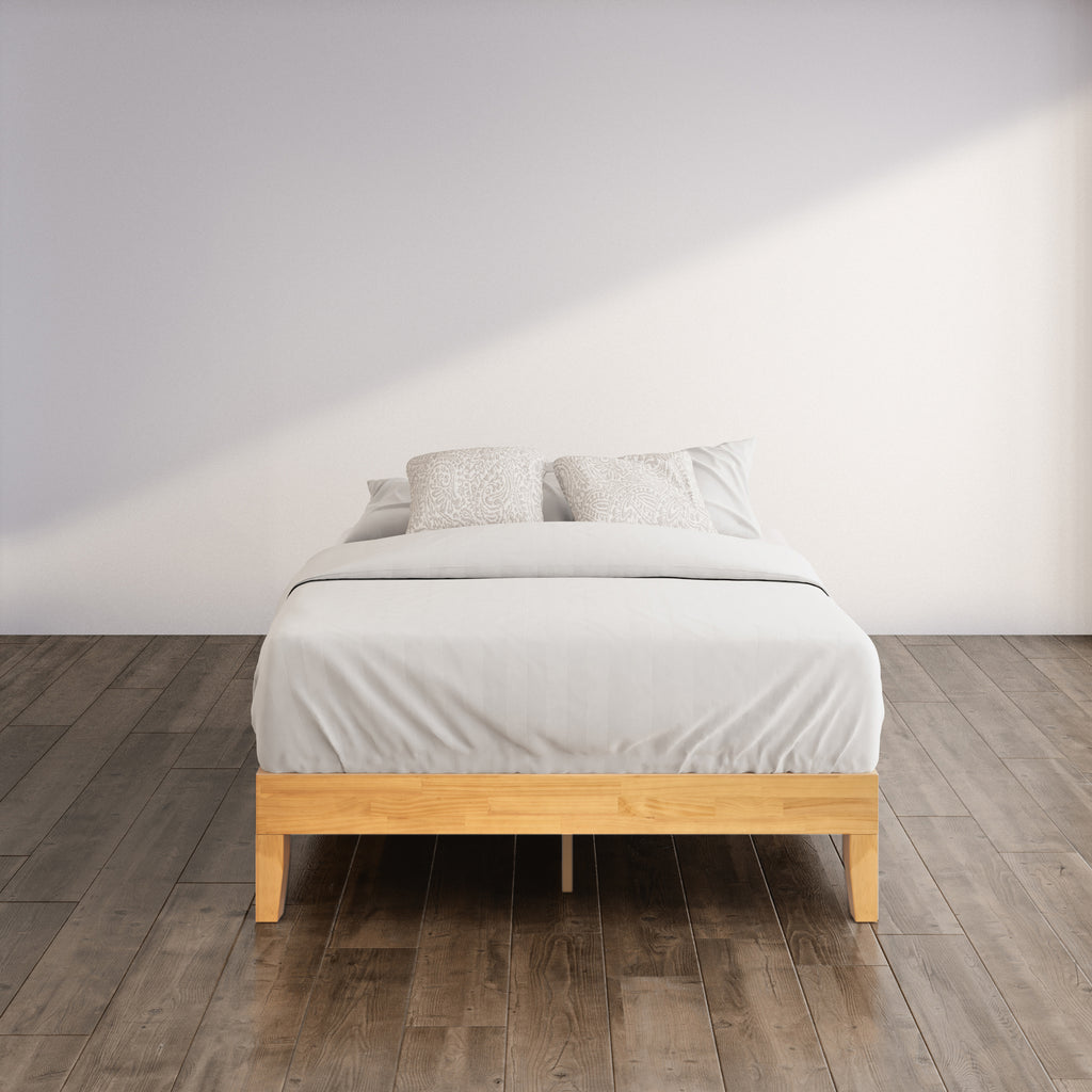 Zinus Moiz Deluxe Wood Platform Bed Frame styled with bedding in a modern bedroom. Natural wood finish adds warmth while strong wooden slats provide reliable mattress support, airflow, and durability, making it a functional and stylish choice for everyday living.