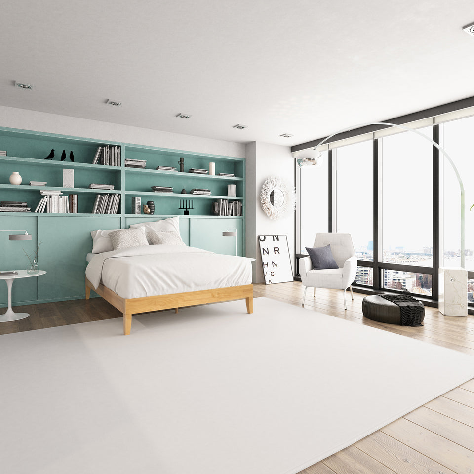 Zinus Moiz Deluxe Wood Platform Bed Frame in a contemporary bedroom with teal shelving and large windows. Minimalist wooden frame supports mattress without box spring, blending sturdy durability with sleek, modern design for a fresh and functional sleep space.