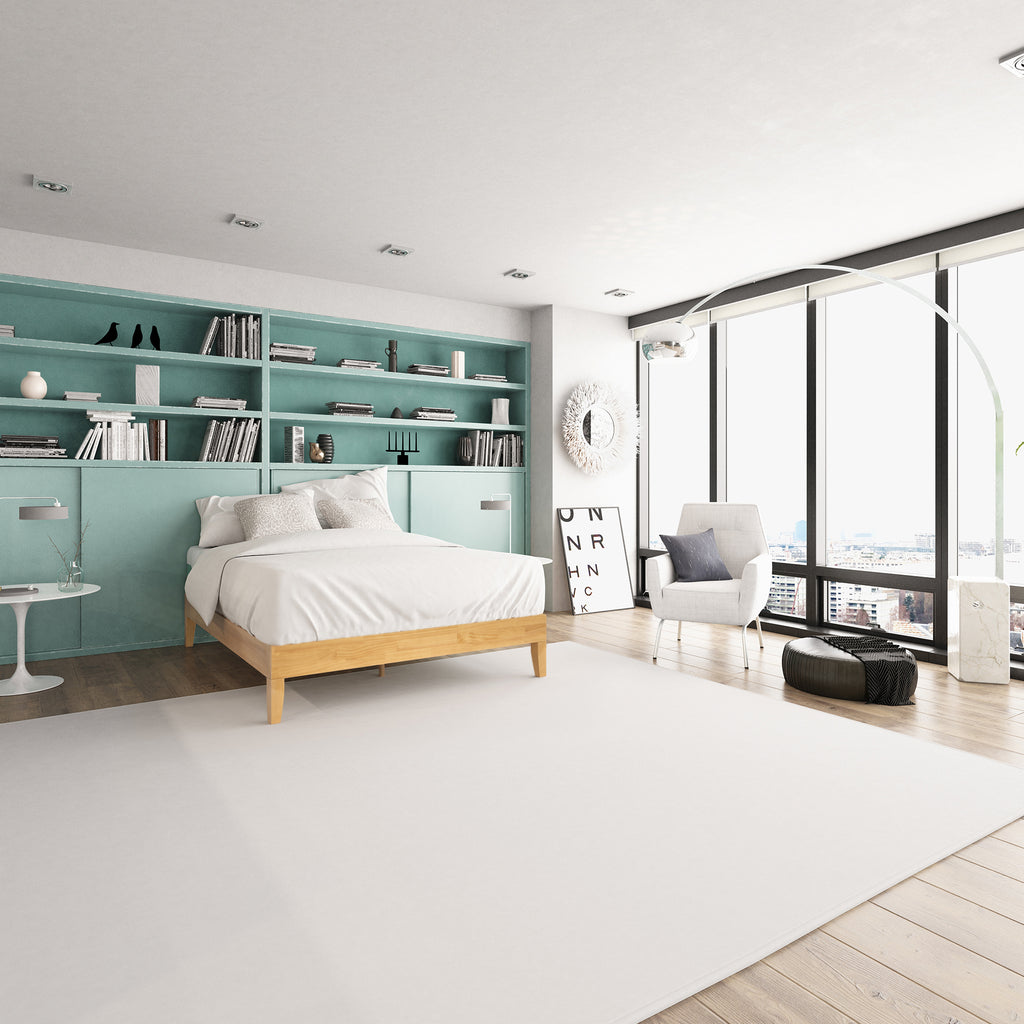 Zinus Moiz Deluxe Wood Platform Bed Frame in a contemporary bedroom with teal shelving and large windows. Minimalist wooden frame supports mattress without box spring, blending sturdy durability with sleek, modern design for a fresh and functional sleep space. 